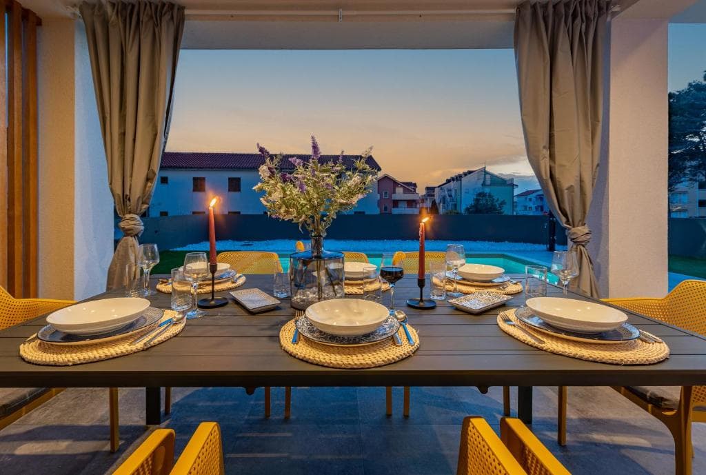 Candlelit terrace dinner at Villa Maslina with pool in the background